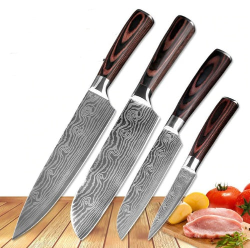 Set of three Damascus steel kitchen knives with wooden handles on a wooden cutting board with vegetables and meat.